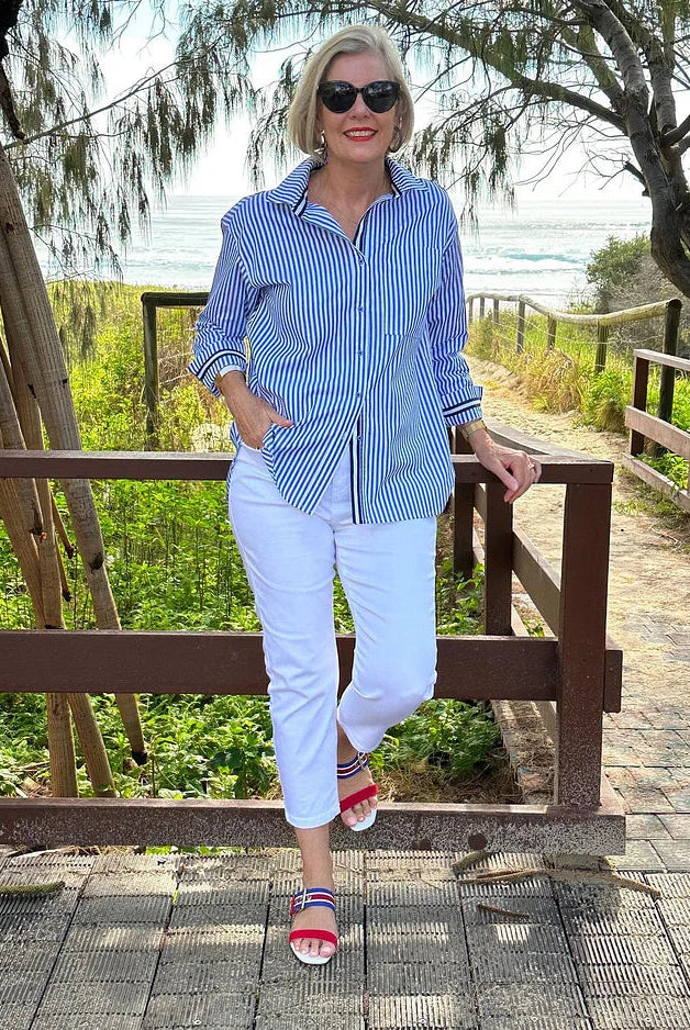 Jasmine Lumina Wear striped button shirt with relaxed fit, casual style, featuring blue and white vertical stripes.