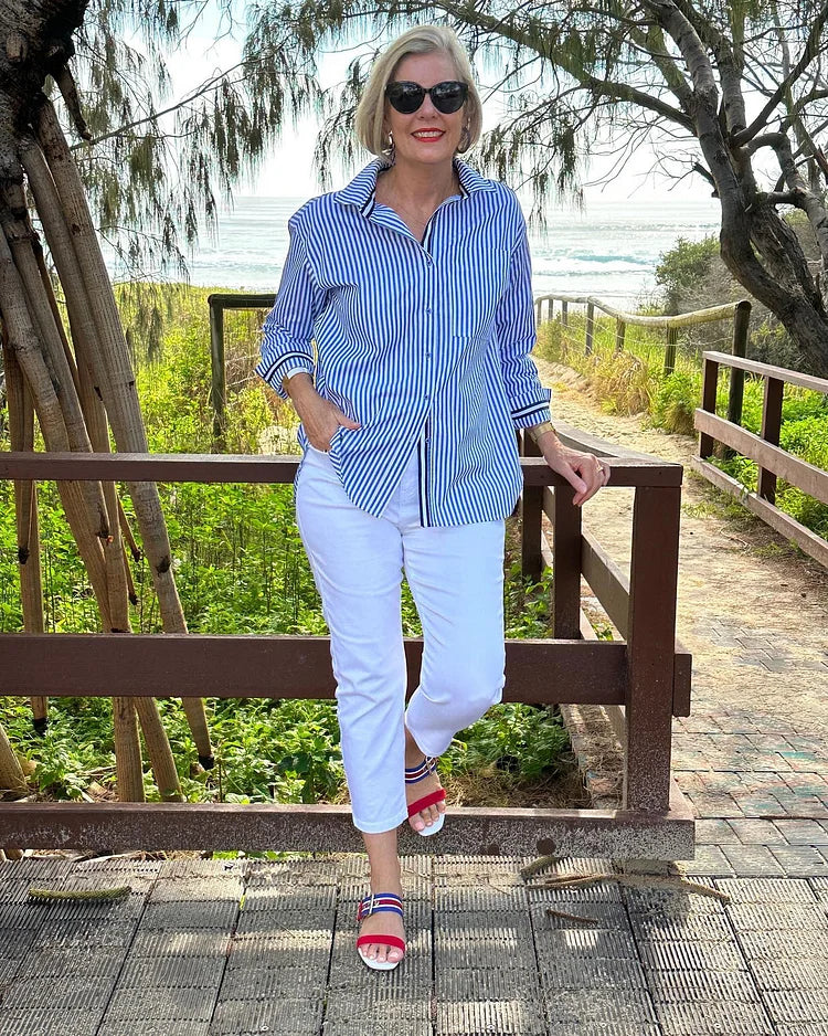 Jasmine Lumina Wear striped button shirt with relaxed fit, casual style, featuring blue and white vertical stripes.