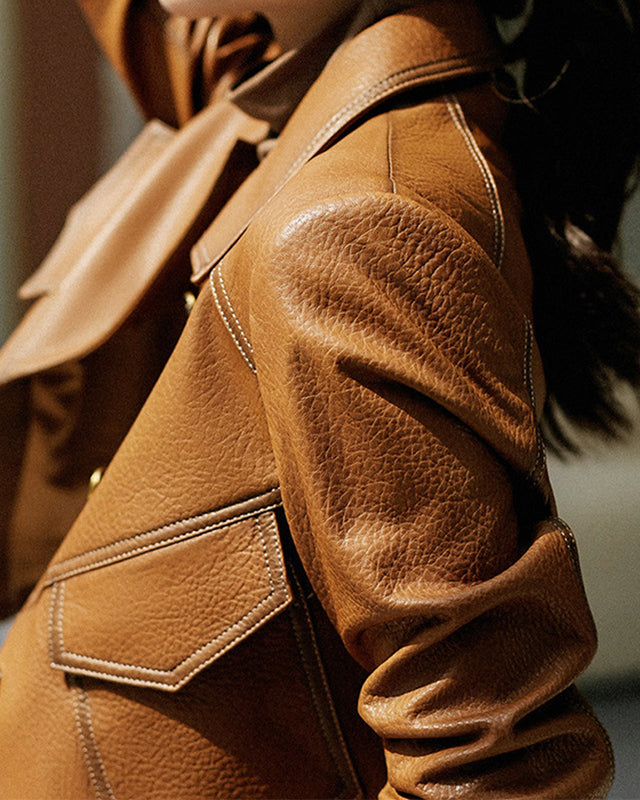Lucille Lumina Wear cropped oversized faux leather jacket with button closure, stylishly displayed on a model.