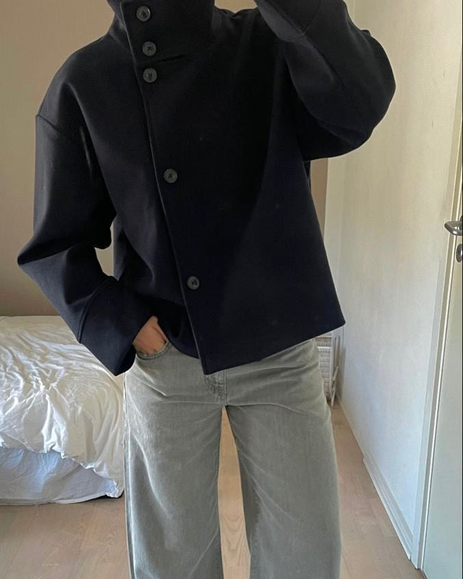 Lumina Wear Martha high-neck cropped jacket with structured design and button closure, shown from the front.