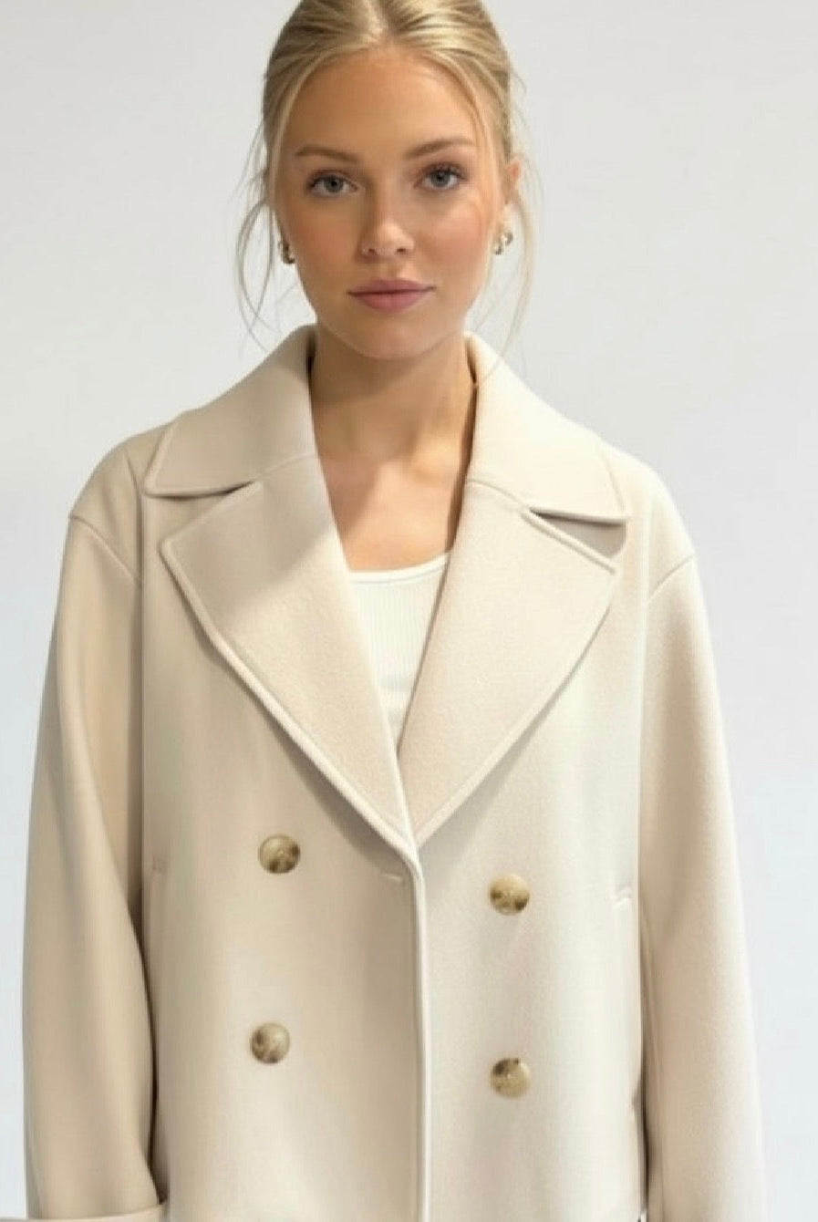 Maya Lumina cropped double-breasted trench coat with structured shoulders, stylish and tailored for a modern look.