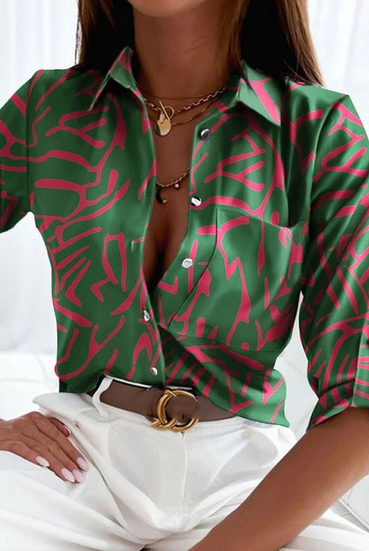 Peyton Lumina Wear bold patterned relaxed fit women's blouse with long sleeves and a round neckline, displayed on a hanger.