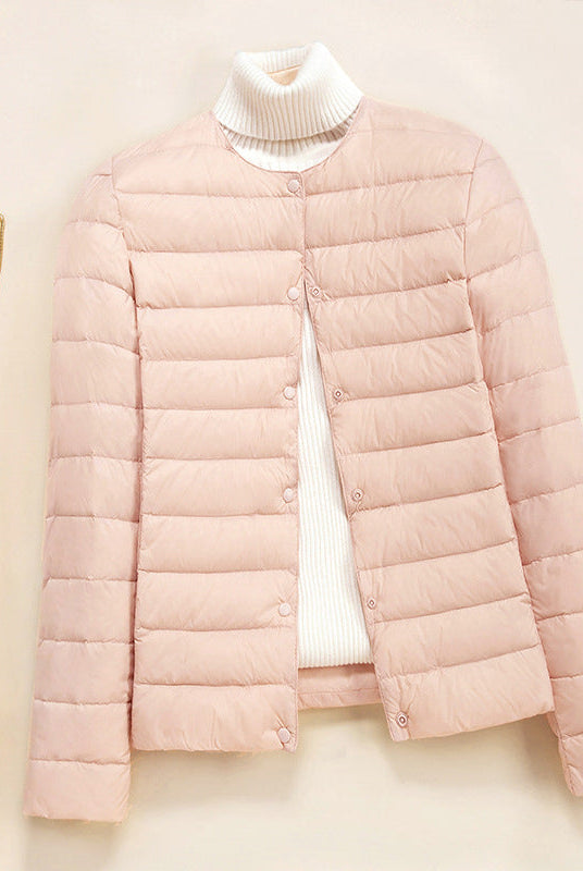 Lightweight quilted puffer jacket by Lumina Wear with snap button closure, shown in a stylish down jacket design.