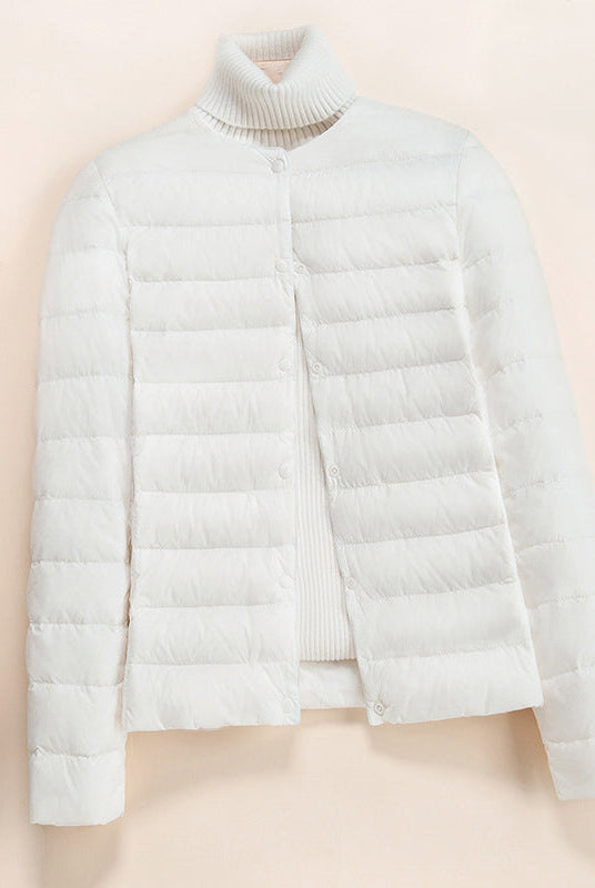 Lumina Wear Serena lightweight quilted puffer jacket with snap button closure, showcasing its padded design and stylish silhouette.
