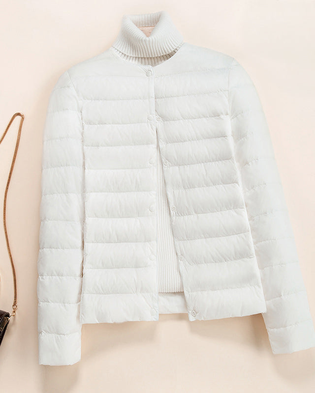 Lumina Wear Serena lightweight quilted puffer jacket with snap button closure, shown in a stylish, insulated design.