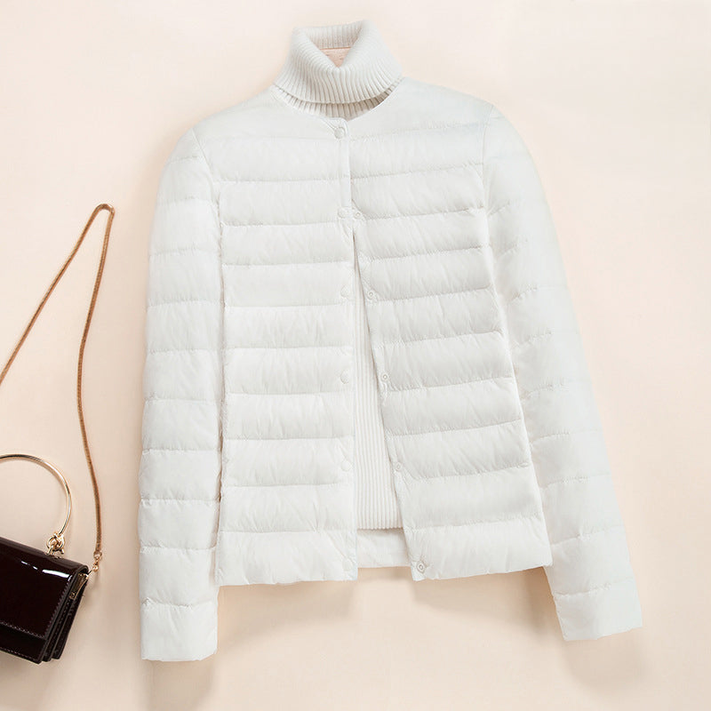 Lumina Wear Serena lightweight quilted puffer jacket with snap button closure, showcasing its padded design and stylish silhouette.