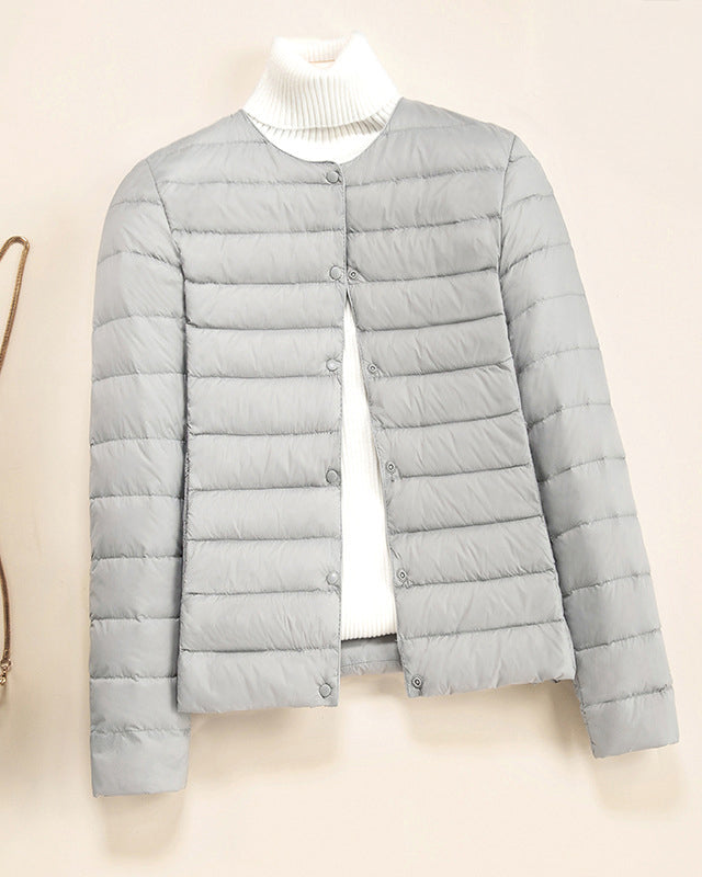 Lumina Wear Serena lightweight quilted puffer jacket with snap button closure, shown in a close-up of its stylish design.