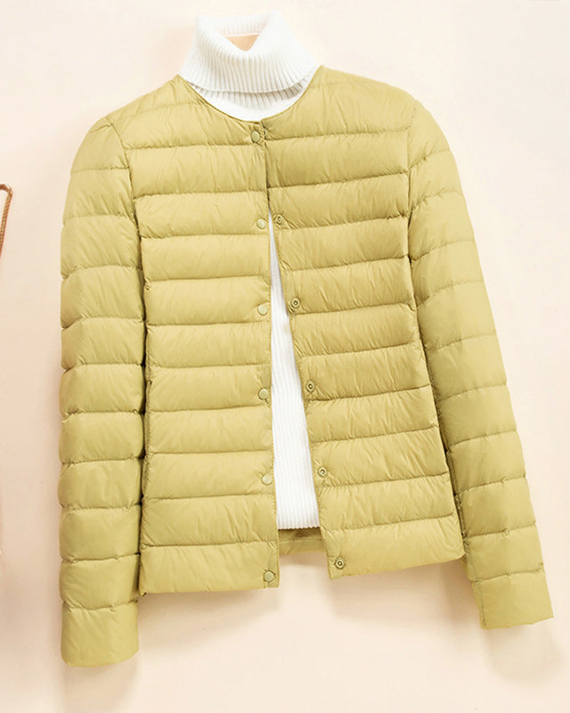 Lumina Wear Serena lightweight quilted puffer jacket with snap button closure, shown in a close-up view.