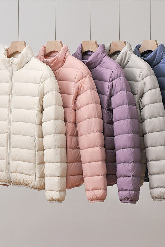 Lightweight pastel insulated Silva Lumina Wear high collar jacket with warmth and style, ideal for cold weather outdoor wear.