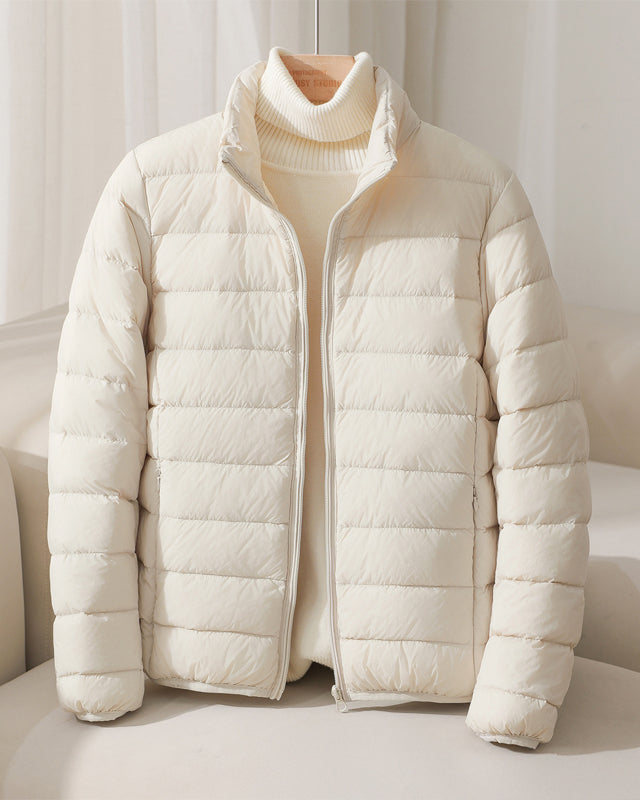 Lumina Wear Silva pastel lightweight insulated high collar jacket displayed with its soft pastel color and cozy high collar design.
