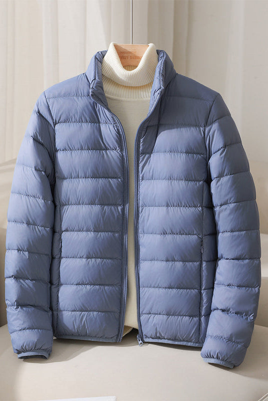 Lightweight pastel insulated Silva Lumina jacket with high collar and zipper, ideal for cold weather outdoor wear.