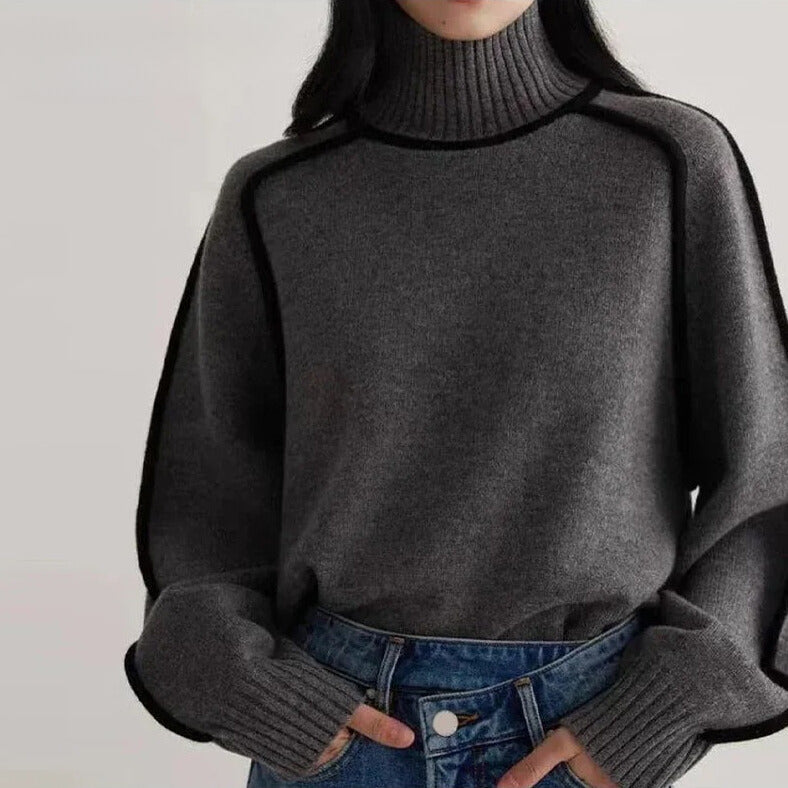 Lumina Wear Sloane minimalist high-neck ribbed sweater with elegant piping, shown in a neutral color on a model.