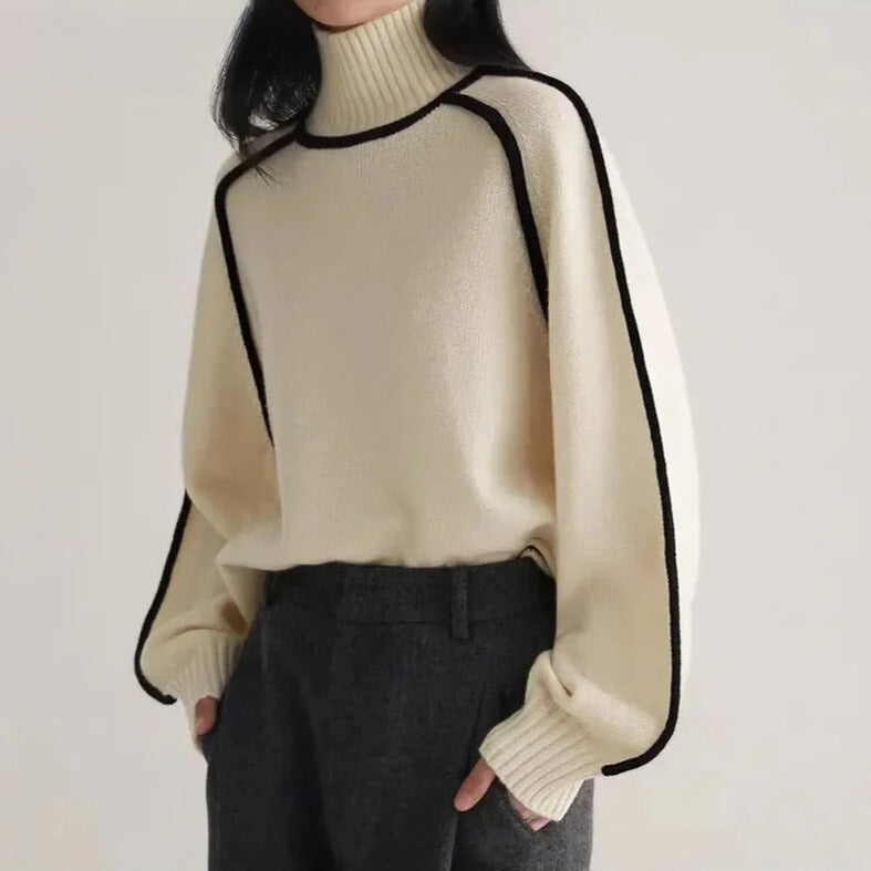 Light gray Sloane Lumina Wear high-neck ribbed sweater with elegant piping, showcasing a minimalist design and fitted silhouette.