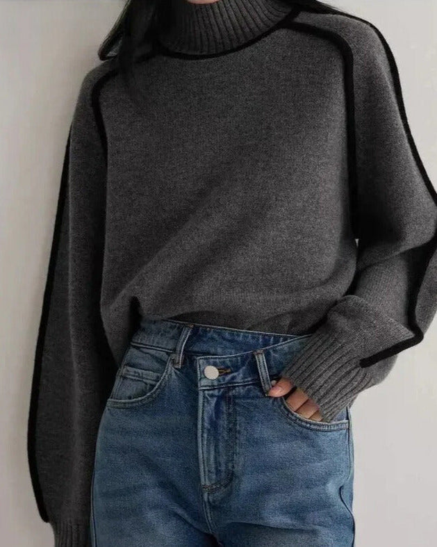 Lumina Wear Sloane minimalist high neck ribbed sweater with elegant piping, shown in a neutral color on a mannequin.