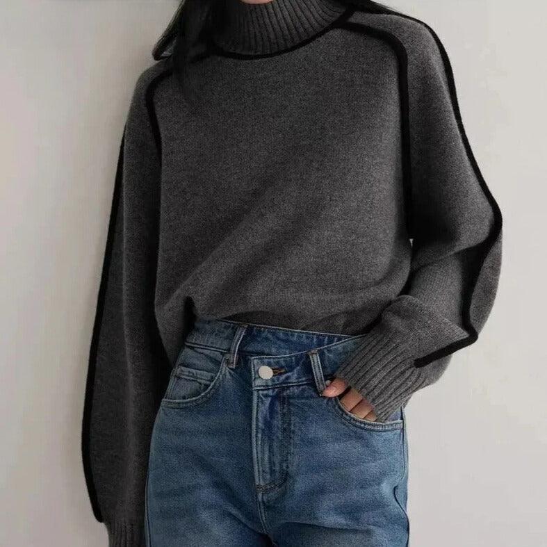 Lumina Wear Sloane minimalist high neck ribbed sweater with elegant piping, shown in a neutral color with a close-up of the textured fabric.