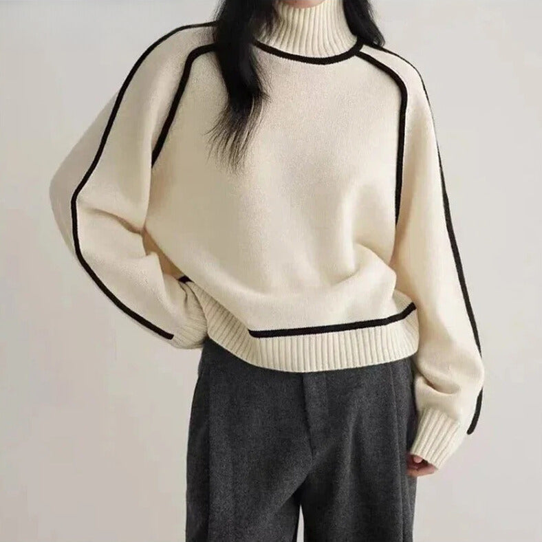 Lumina Wear Sloane minimalist high neck ribbed sweater with elegant piping, shown in a neutral color, close-up of textured fabric.