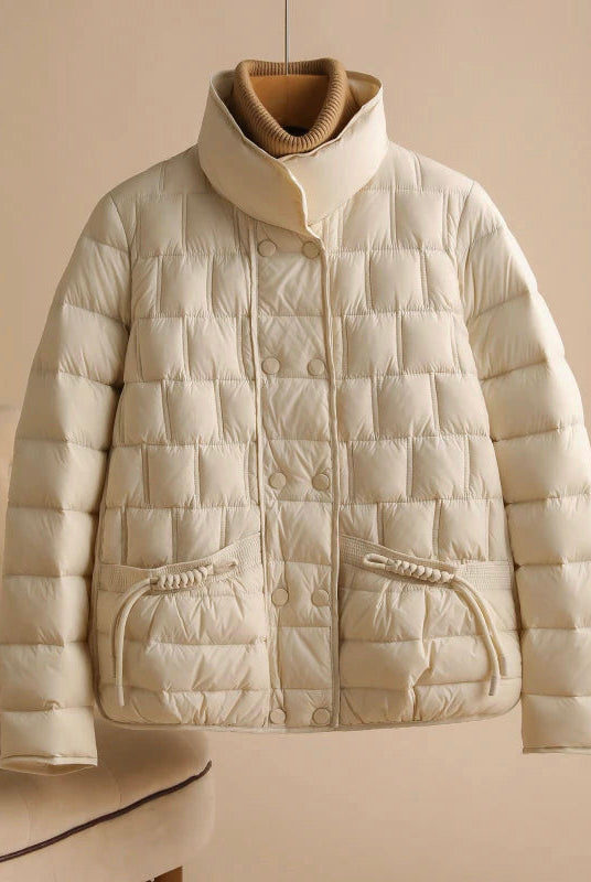 Elegant Lumina Wear Sofia double-breasted insulated women's jacket in broadcloth, shown with a stylish collar and quilted design.
