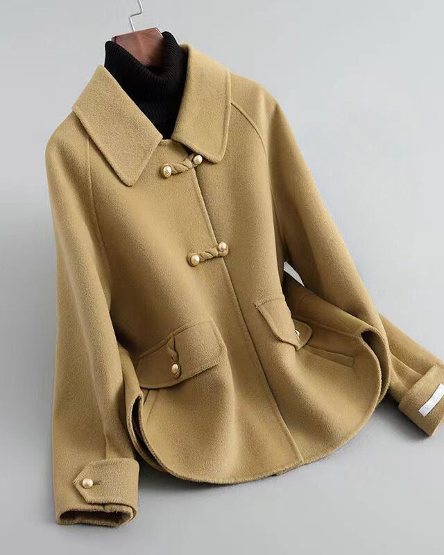 Elegant knit coat by Lumina Wear featuring pearl buttons and a distinctive collar, showcased in a stylish front view.