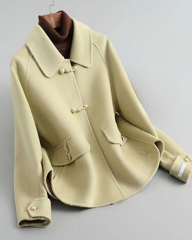Lumina Wear Sofia elegant knit coat with pearl buttons and a distinctive collar, showcasing a stylish and cozy outerwear design.
