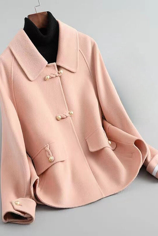 Elegant knit coat by Lumina Wear featuring pearl buttons and a distinctive collar, styled for a sophisticated look.