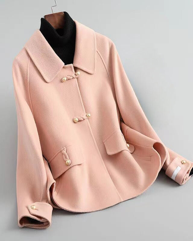 Lumina Wear Sofia elegant knit coat featuring pearl buttons and a distinctive collar, displayed on a neutral background.