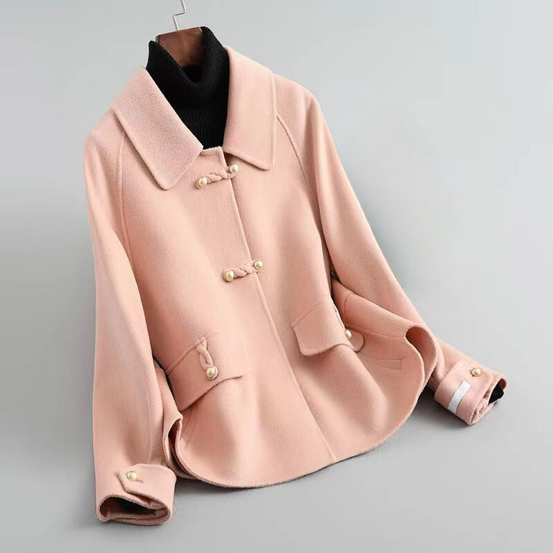 Elegant knit coat by Lumina Wear featuring pearl buttons and a distinctive collar, styled for a sophisticated look.