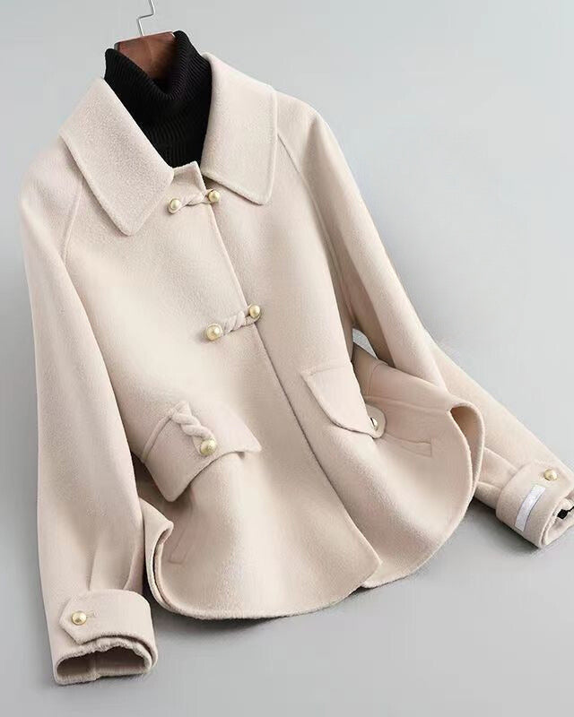 Elegant knit coat by Lumina Wear featuring pearl buttons and a distinctive collar, showcased in a stylish and cozy design.