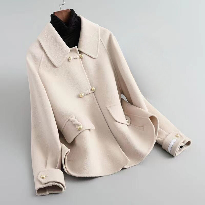 Elegant Lumina Wear Sofia knit coat with pearl buttons and a distinctive collar, showcasing a stylish and cozy outerwear piece.