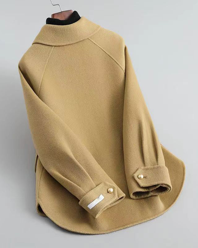 Elegant knit coat by Lumina Wear featuring pearl buttons and a distinctive collar, shown in a stylish, close-up view.