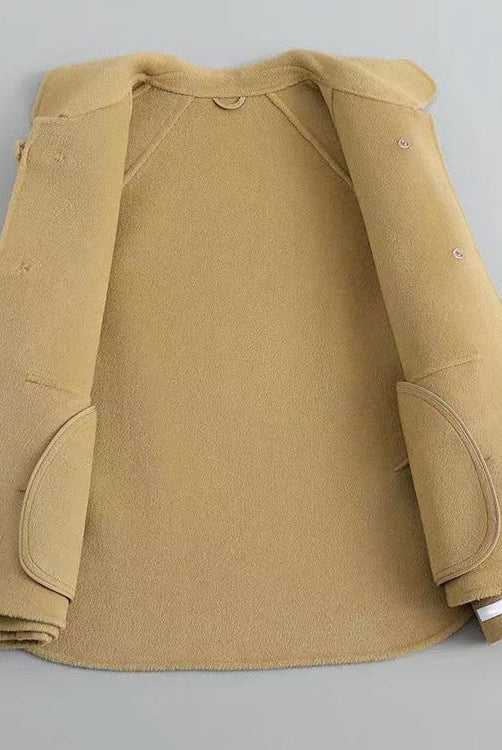 Elegant knit coat by Lumina Wear featuring pearl buttons and a distinctive collar, shown on a model.