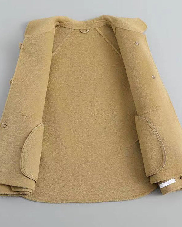 Elegant knit coat by Lumina Wear featuring pearl buttons and a distinctive collar, shown in a stylish and cozy design.