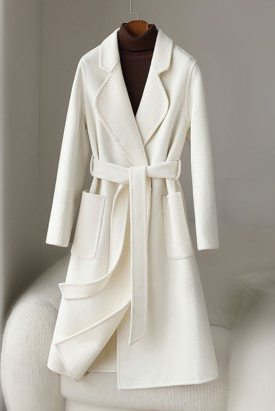 Elegant monochrome wool coat with waist belt from Lumina Wear, shown in a stylish women's coat with a tailored fit and classic design.