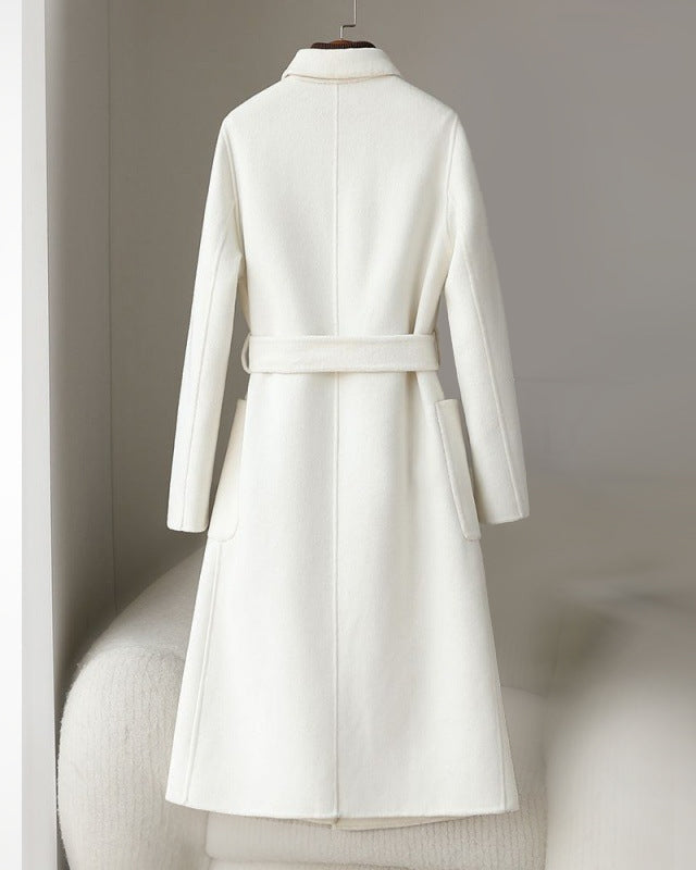 Elegant monochrome wool coat with waist belt by Lumina Wear, featuring a tailored fit and stylish design.