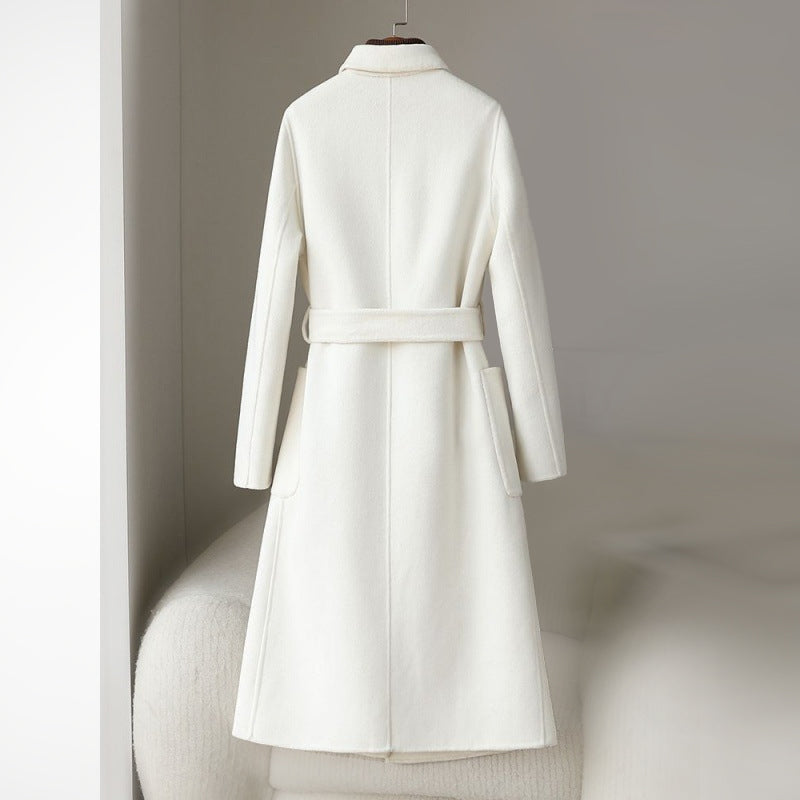 Elegant monochrome wool coat with waist belt, women's fashion by Lumina Wear, featuring a tailored fit and sophisticated style.