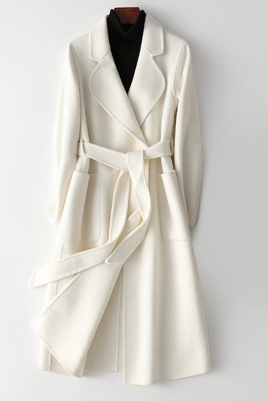 Elegant monochrome wool coat with waist belt from Lumina Wear, featuring a tailored fit and sophisticated style for women.
