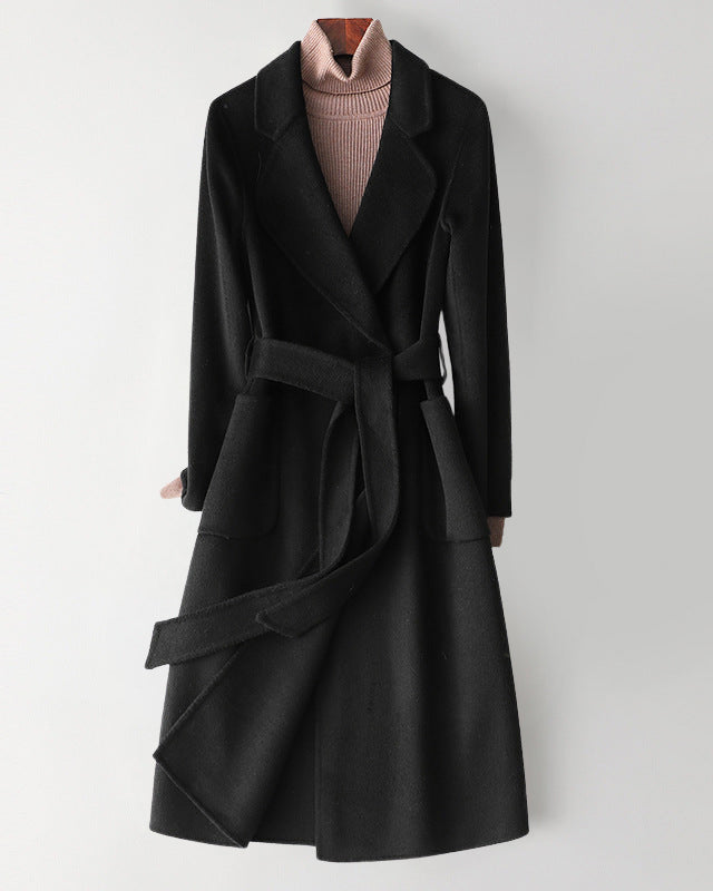 Elegant monochrome wool coat with waist belt from Lumina Wear, featuring a tailored fit and classic design.