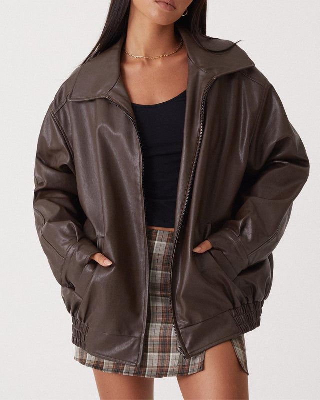Lumina Wear Sofia oversized faux leather bomber jacket with relaxed fit, shown on a model in a casual outdoor setting.