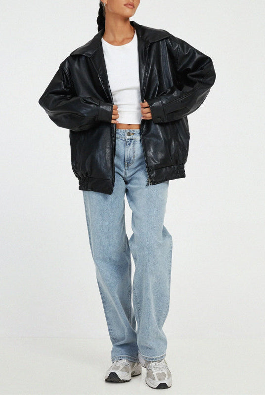 Lumina Wear Sofia oversized faux leather bomber jacket with relaxed fit, shown in a stylish, casual outdoor setting.