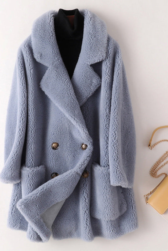 Sofia oversized textured shearling winter coat with wide lapels by Lumina Wear, shown on a model in a cozy winter setting.