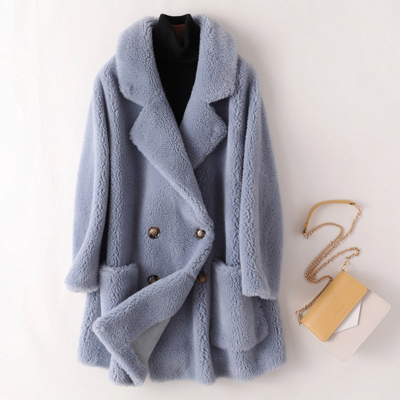 Sofia oversized textured shearling winter coat with wide lapels by Lumina Wear, shown on a model in a cozy winter setting.