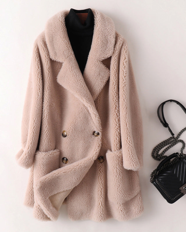Sofia oversized textured shearling winter coat with wide lapels from Lumina Wear, shown hanging on a coat rack.