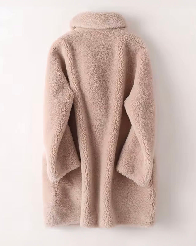 Lumina Wear Sofia oversized shearling winter coat with textured fabric and wide lapels, displayed hanging on a coat rack.