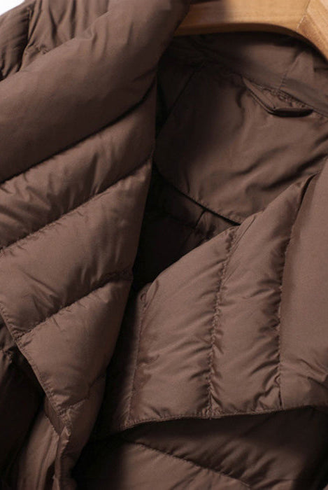 Lumina Wear Sofia quilted structured down jacket with tie belt, showcasing a fitted design and stylish collar detail.