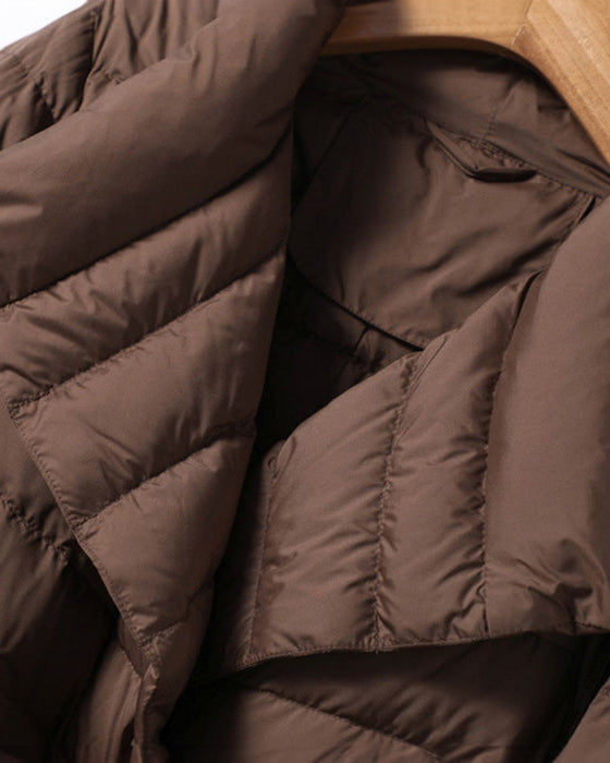 Lumina Wear Sofia quilted structured down jacket with tie belt, featuring a sleek design and cozy insulation.