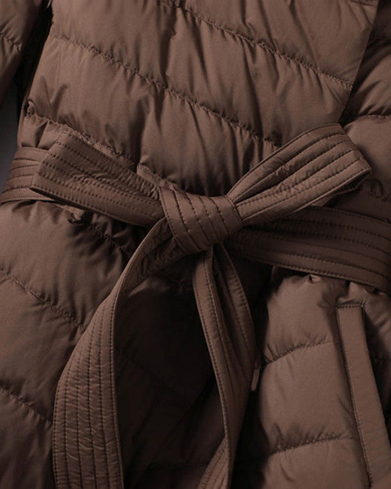 Lumina Wear Sofia quilted structured down jacket with tie belt, featuring a sleek design and cozy insulation.