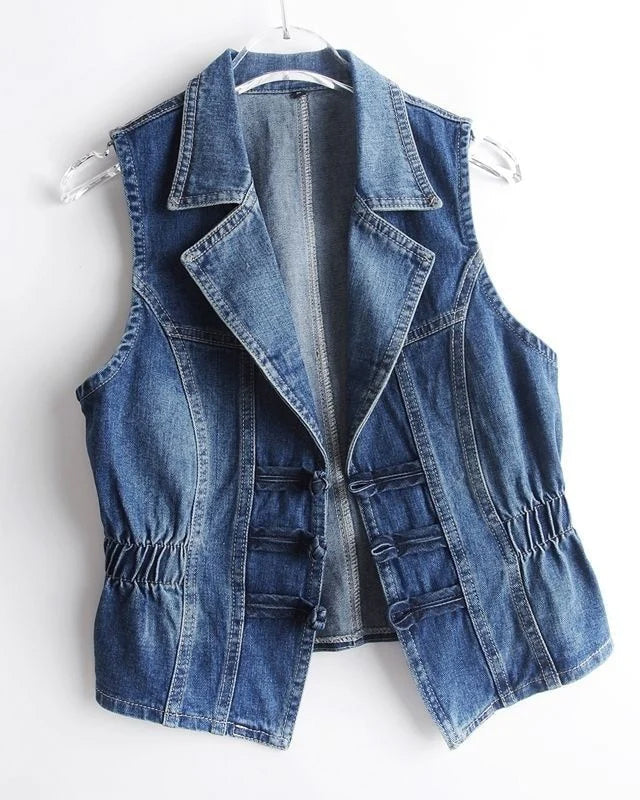 Celestial medium blue washed denim vest with toggle fastenings from Lumina Wear, styled with a collar and sleeveless design.