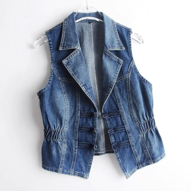 Valentina Celestial medium blue washed denim vest with toggle fastenings by Lumina Wear, displayed on a hanger.
