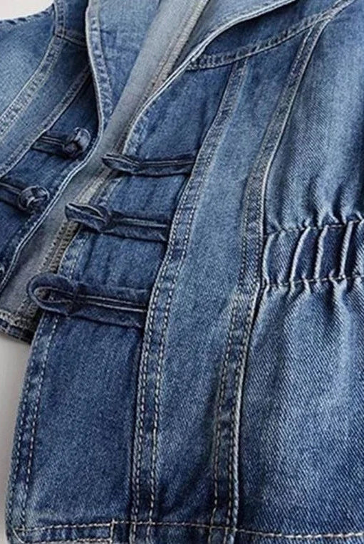 Celestial medium blue washed denim vest with toggle fastenings by Lumina Wear, featuring a stylish sleeveless design.