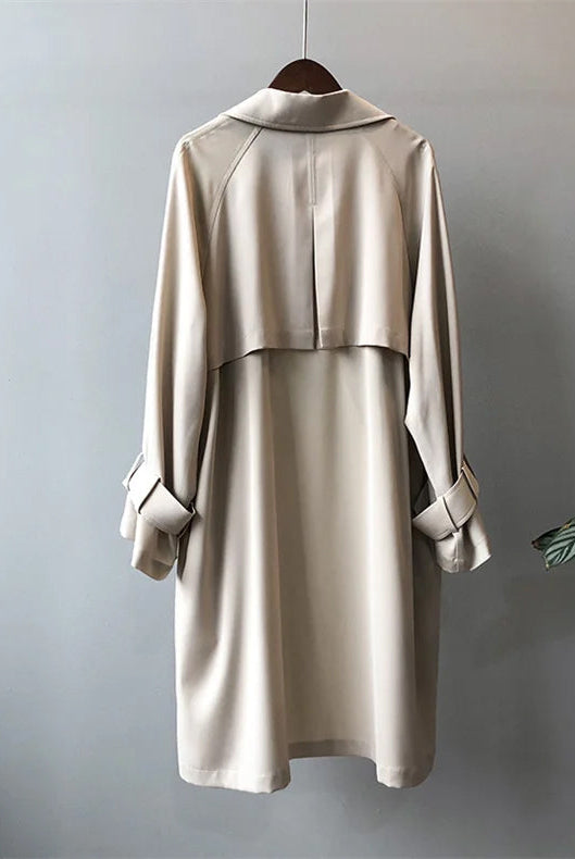 Elegant black women's trench coat with classic closure and belt from Lumina Wear, featuring a tailored fit and stylish design.