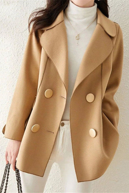 Elegant double-breasted wool coat with structured lapels from Lumina Wear, styled on a woman, in a neutral color.